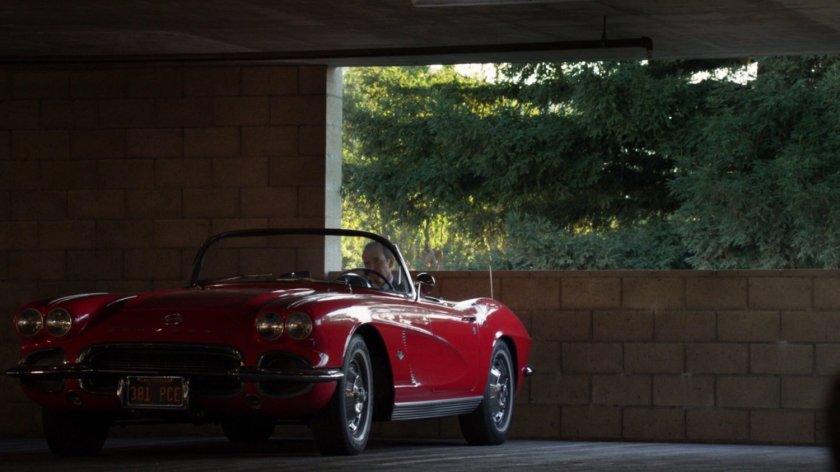 Coulson in Lola sitting in a parking garage.