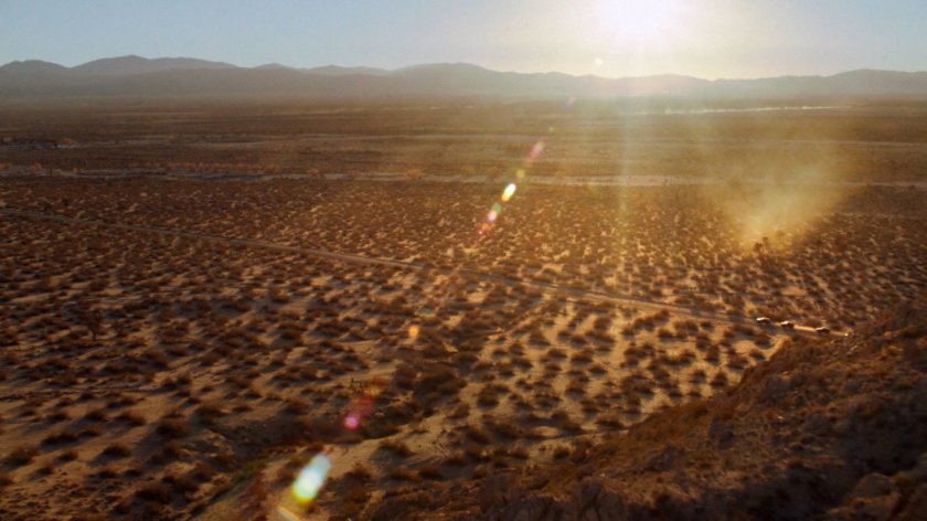 Aerial shot of Death Valley road with SHIELD SUVs.