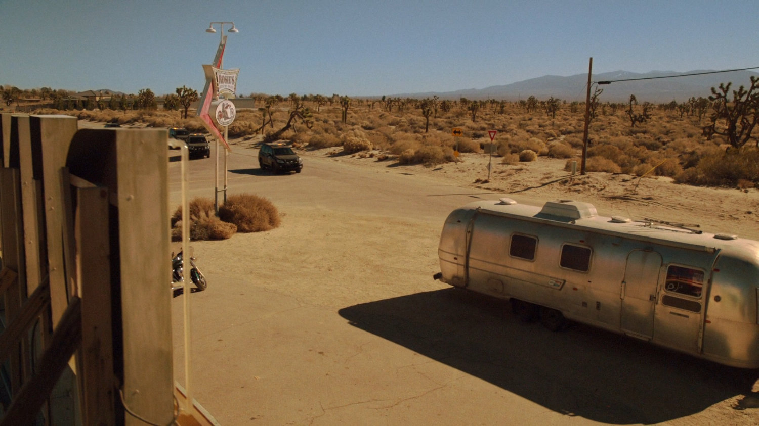 SHIELD SUVs pull up outside Rosie's Desert Oasis.