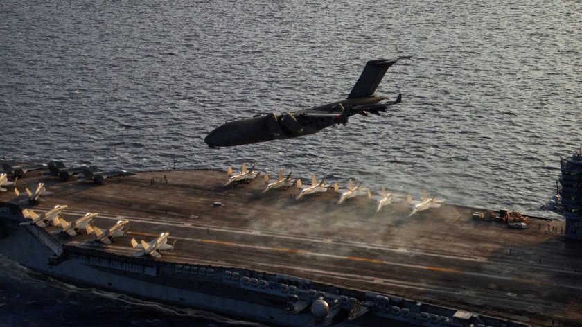 The Bus lands on the deck of an aircraft carrier.