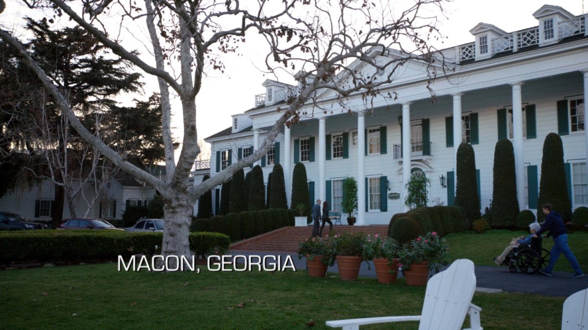 Exterior of a large white mansion. Text: Macon, Georgia.