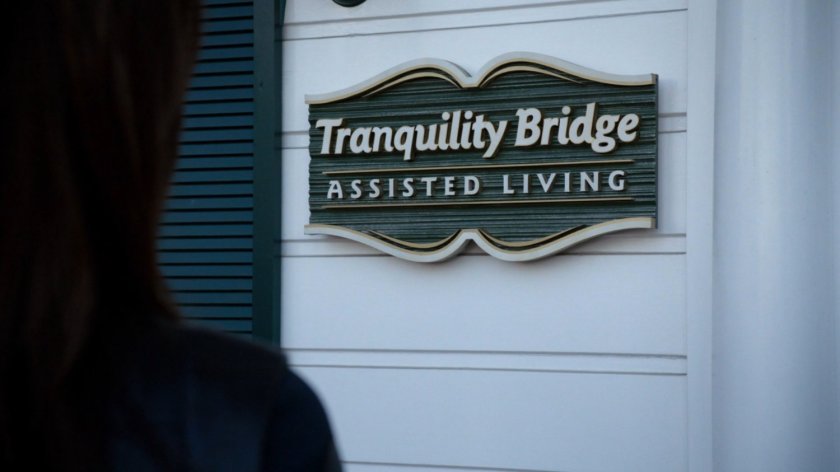 Closeup of sign on front of white mansion. Tranquility Bridge, Assisted Living.
