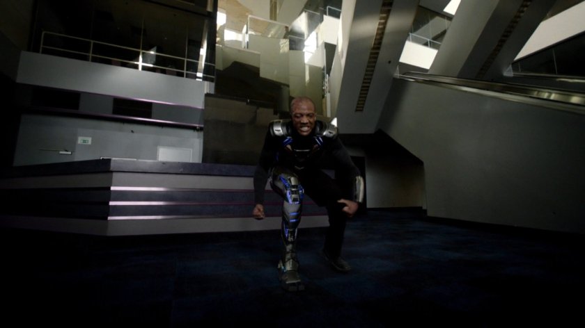 Deathlok does a super hero landing inside an abandoned racetrack.