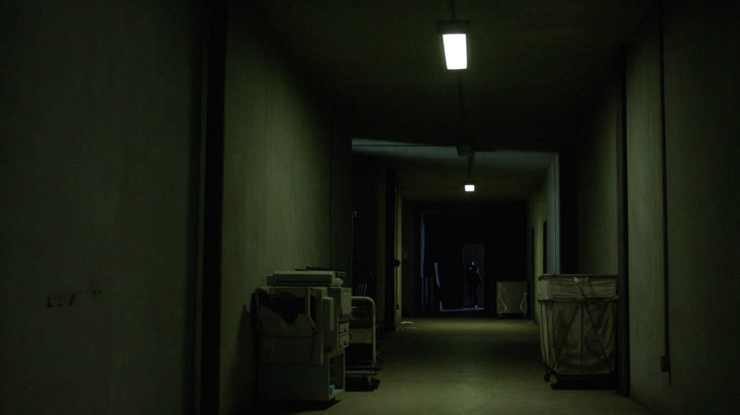 A darkened hallway in an abandoned racetrack.