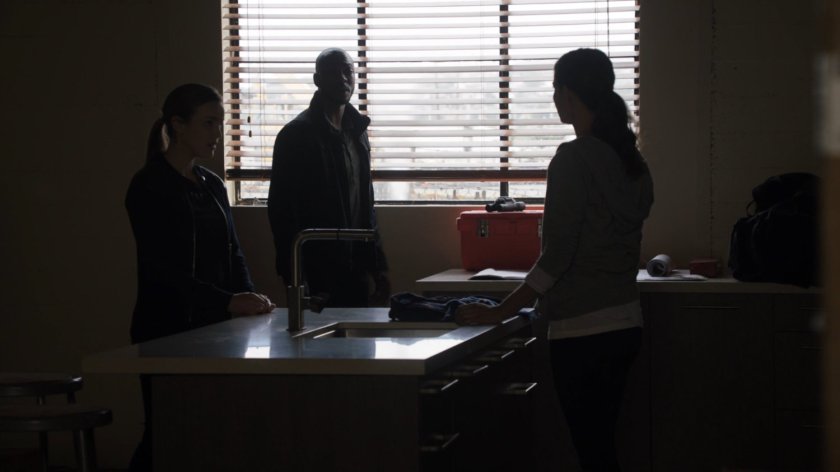 Simmons and Tripp talk with Audrey Nathan inside a Portland apartment building.