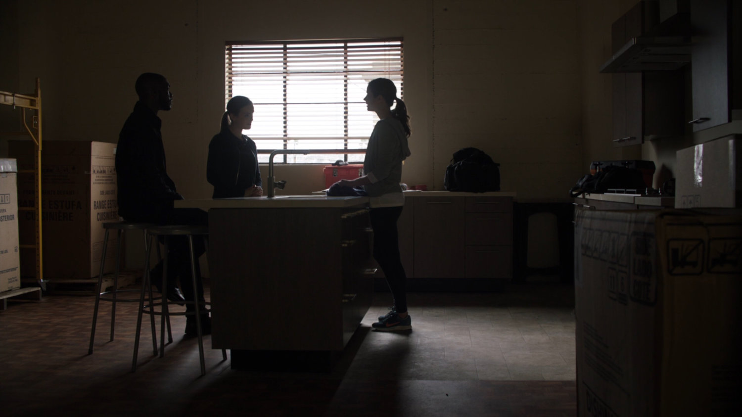 Simmons and Tripp talk with Audrey Nathan inside a Portland apartment building.