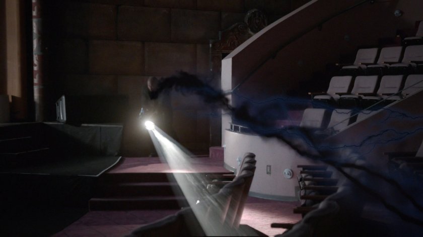 Spotlight illuminating Portland theater with strange wispy black smoke.