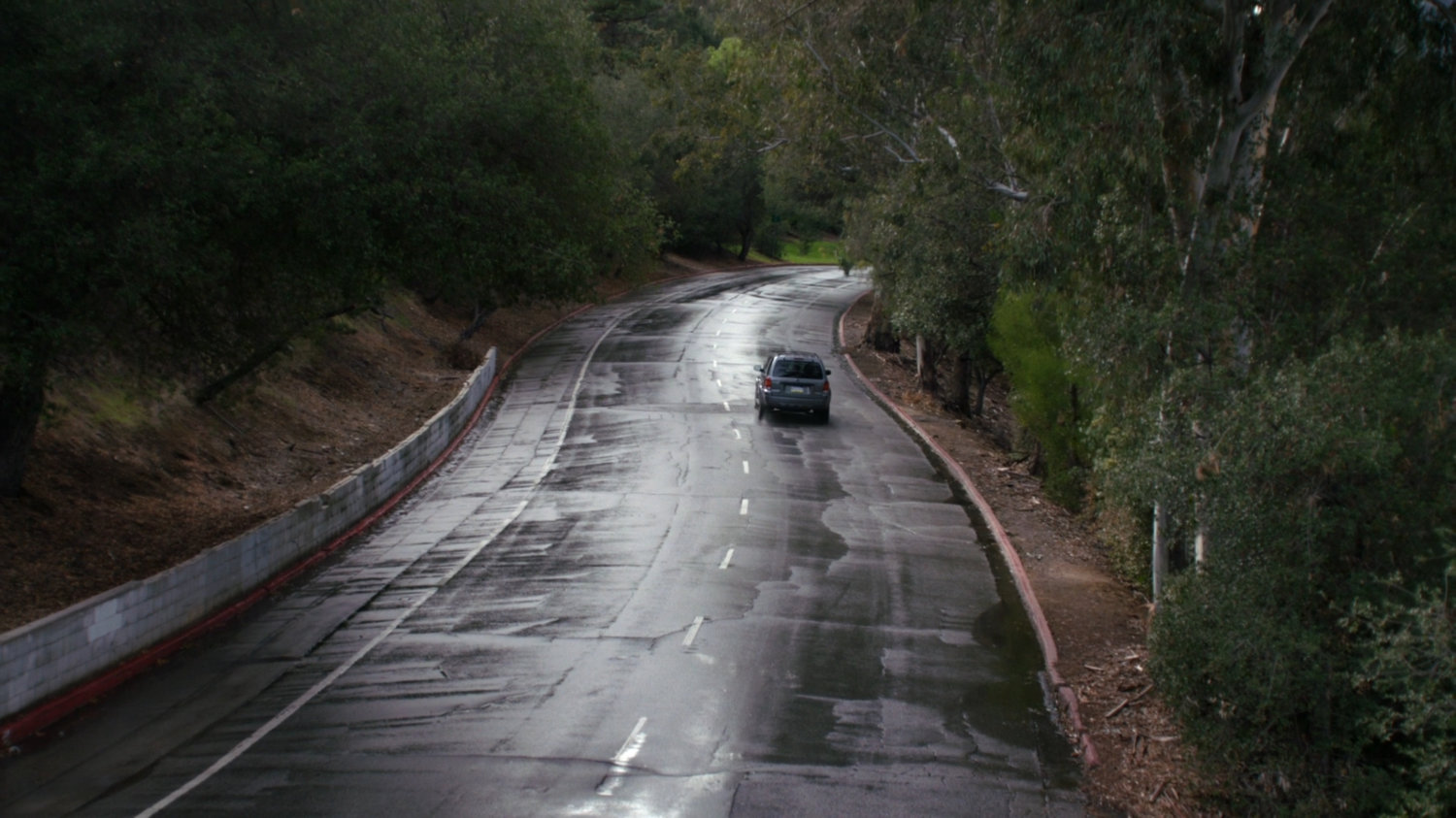 A car drives off down an Ontario road.