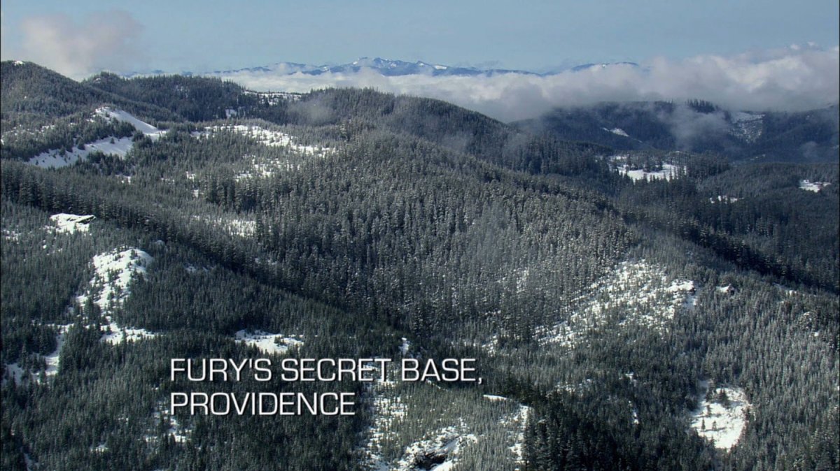A snow covered forest in Ontario Canada. Text: Fury's Secret Base, Providence.