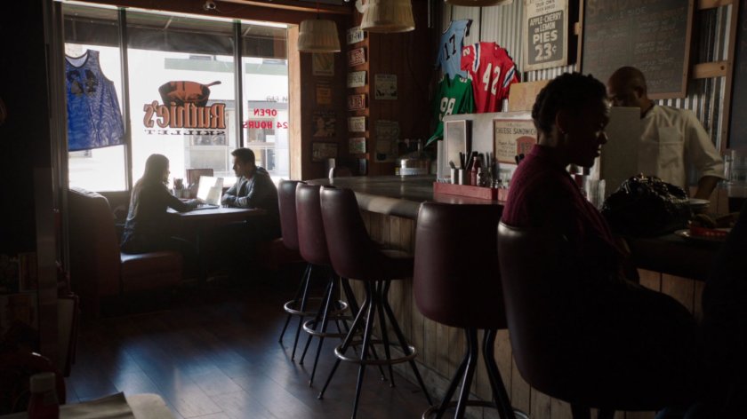 Ward and Skye in Ruthie's Skillet diner by the window.