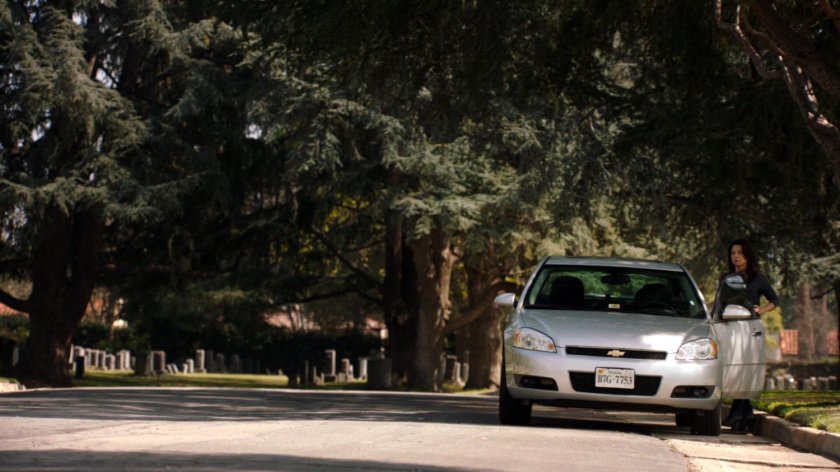 Agent May gets into a car on a cemetery road.