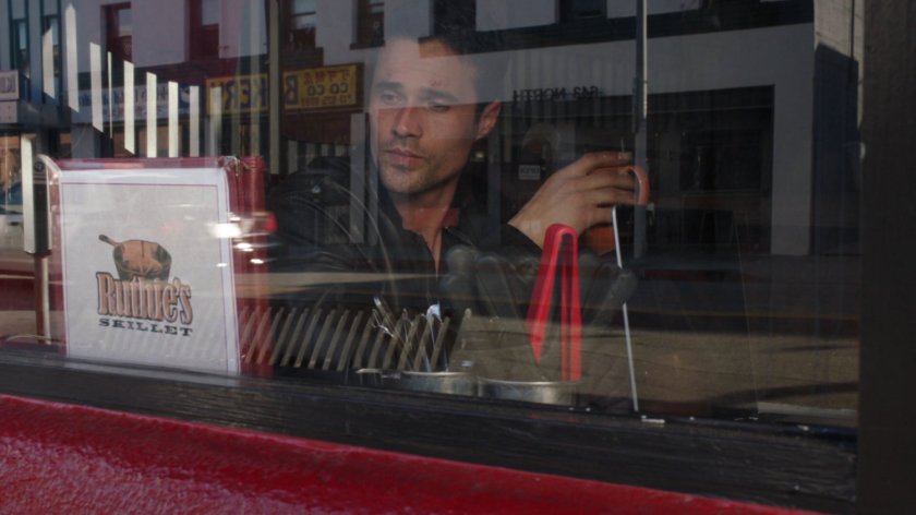Ward looking out window at Ruthie's Skillet diner.