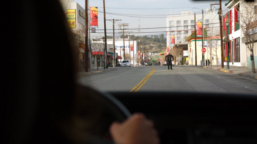POV of Deathlok in street from the front of a police car.