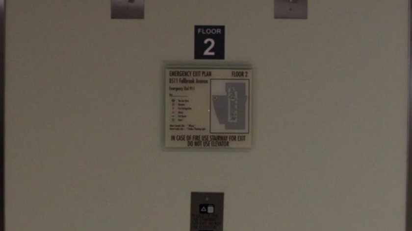 Close up of elevator placard with address of filming location.