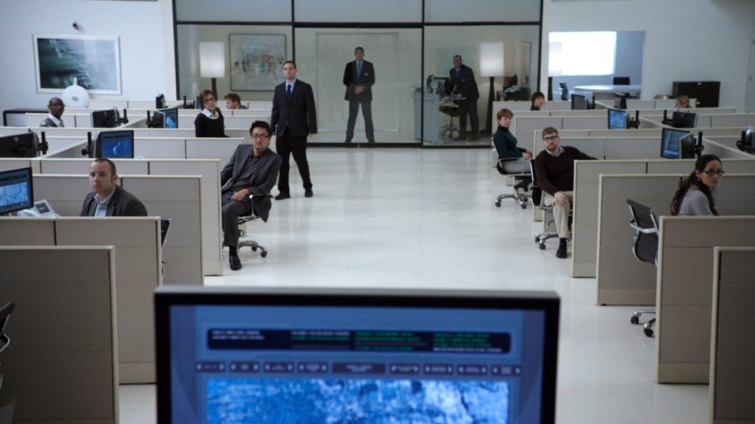 Workers in cubes inside white, sterile Cybertek offices.