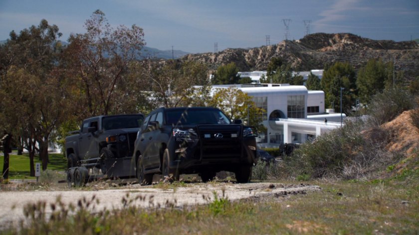 SHIELD SUV tows a truck into the hills outside the Cybertek Manufacturing plant.