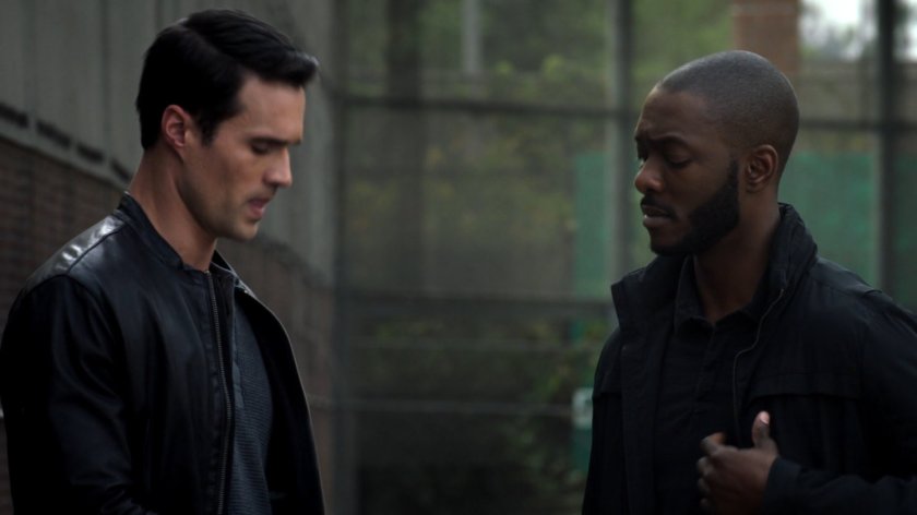 Ward and Triplett talk by a large chain link fence.