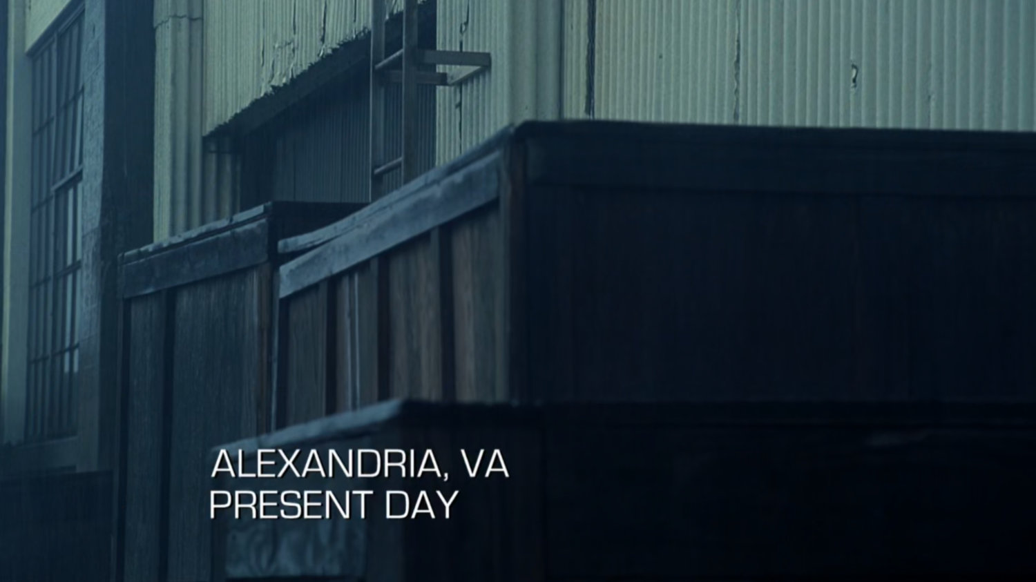 Exterior warehouse. Text: Alexandria, VA, Present Day.