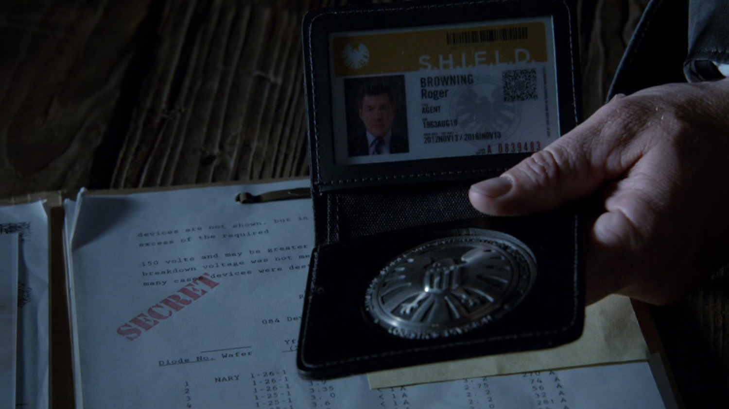 Close up of Roger Browning's SHIELD badge.
