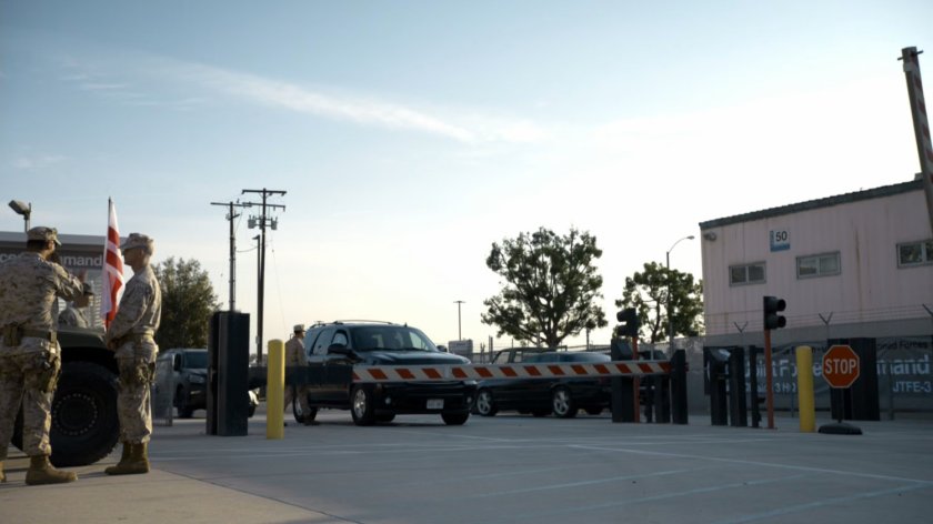 SUV pulls up at security checkpoint for the Joint Task Force Epsilon Marine Base.