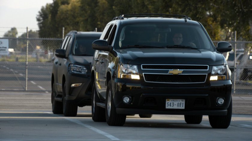 Two black SUVs pull through security checkpoint for the Joint Task Force Epsilon Marine Base.