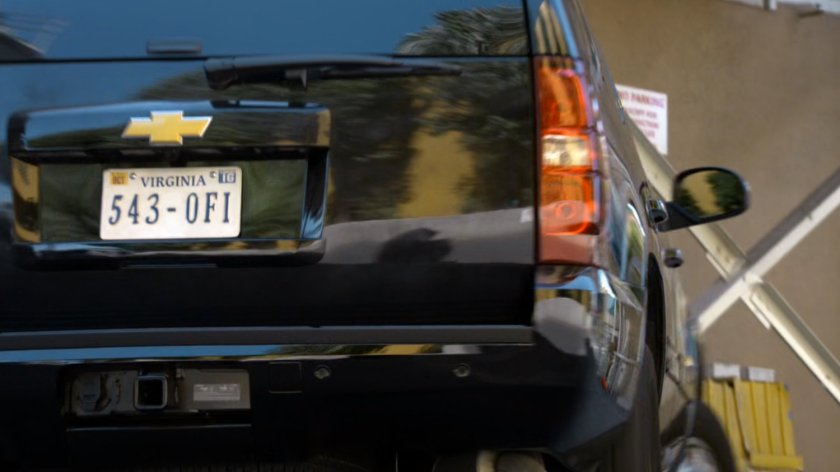 SUV exiting warehouse.