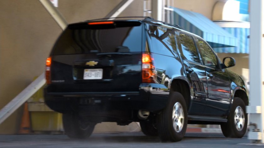 SUV exiting warehouse.