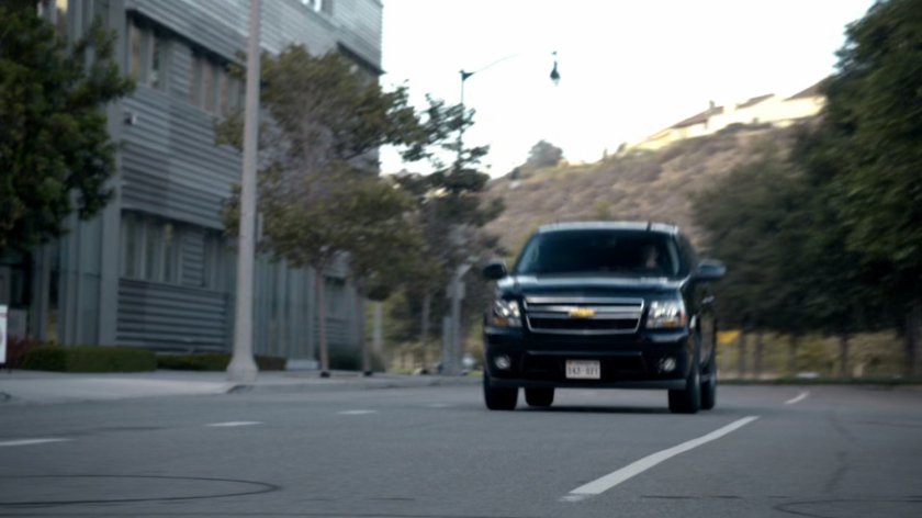 SUV driving down street.