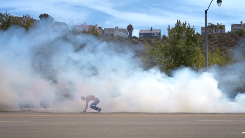 Carl Creel in road surrounded by smoke.