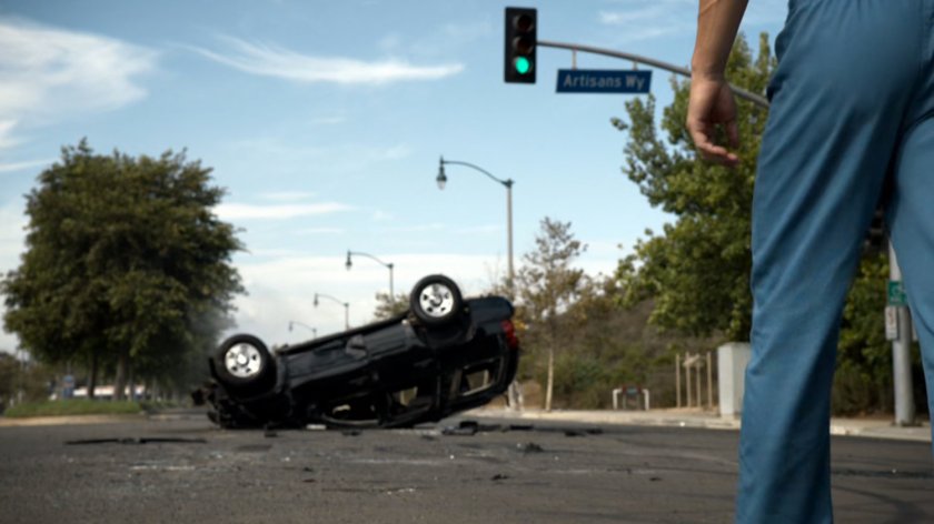 Carl Creel approaching upside down SUV in intersection.