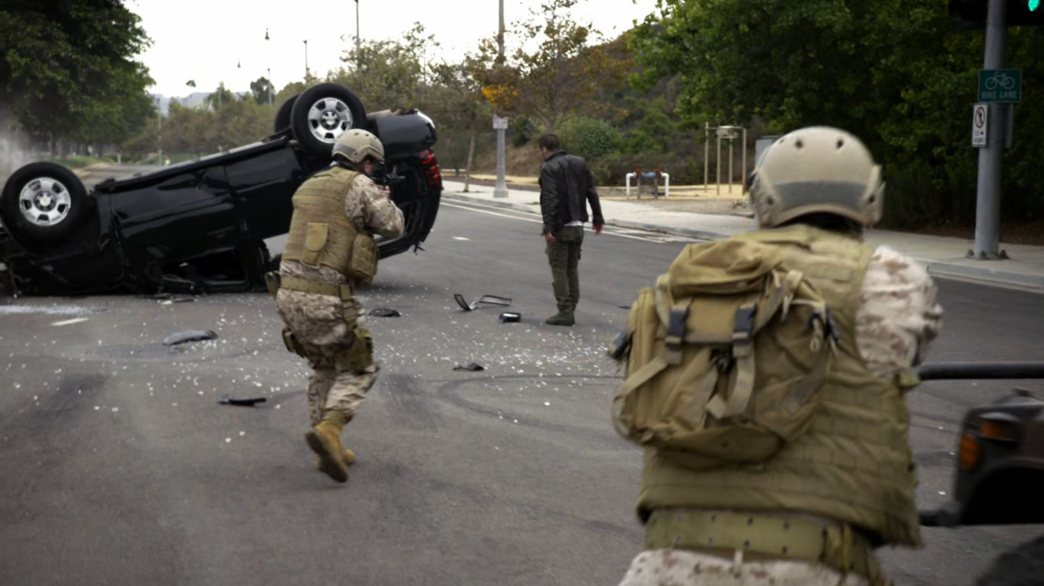 Soldiers approach Hunter and overturned SUV in intersection.