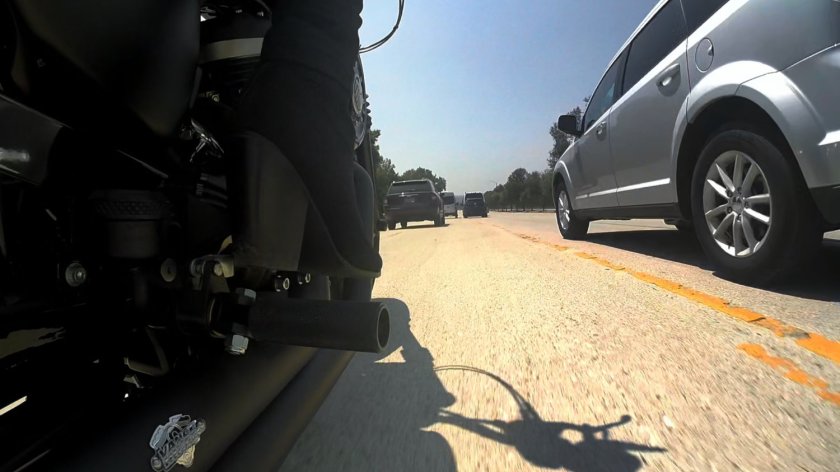 POV from motorcycle as it passes a car.