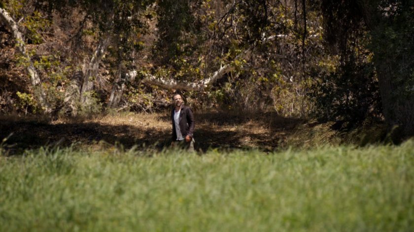 Hunter standing in the middle of a field.