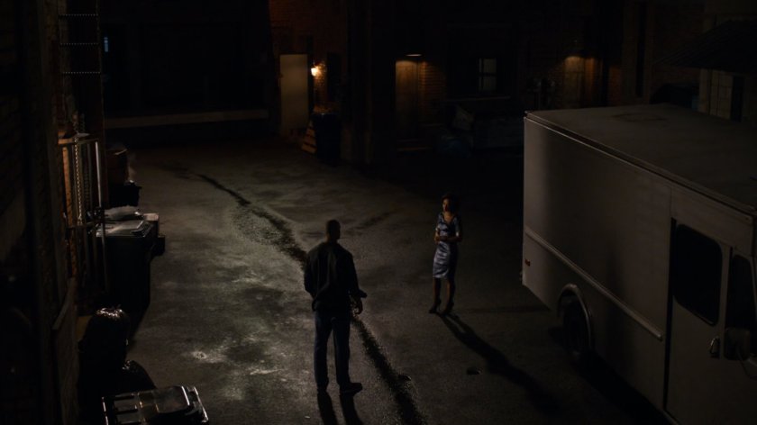 Carl Creel outside his van with Raina in a dark alley.