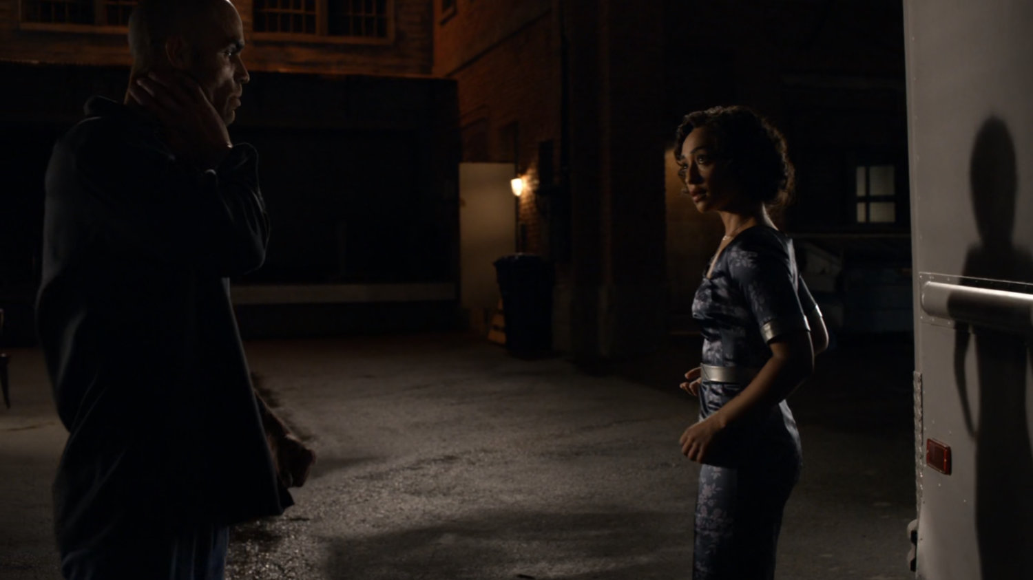 Carl Creel outside his van with Raina in a dark alley.