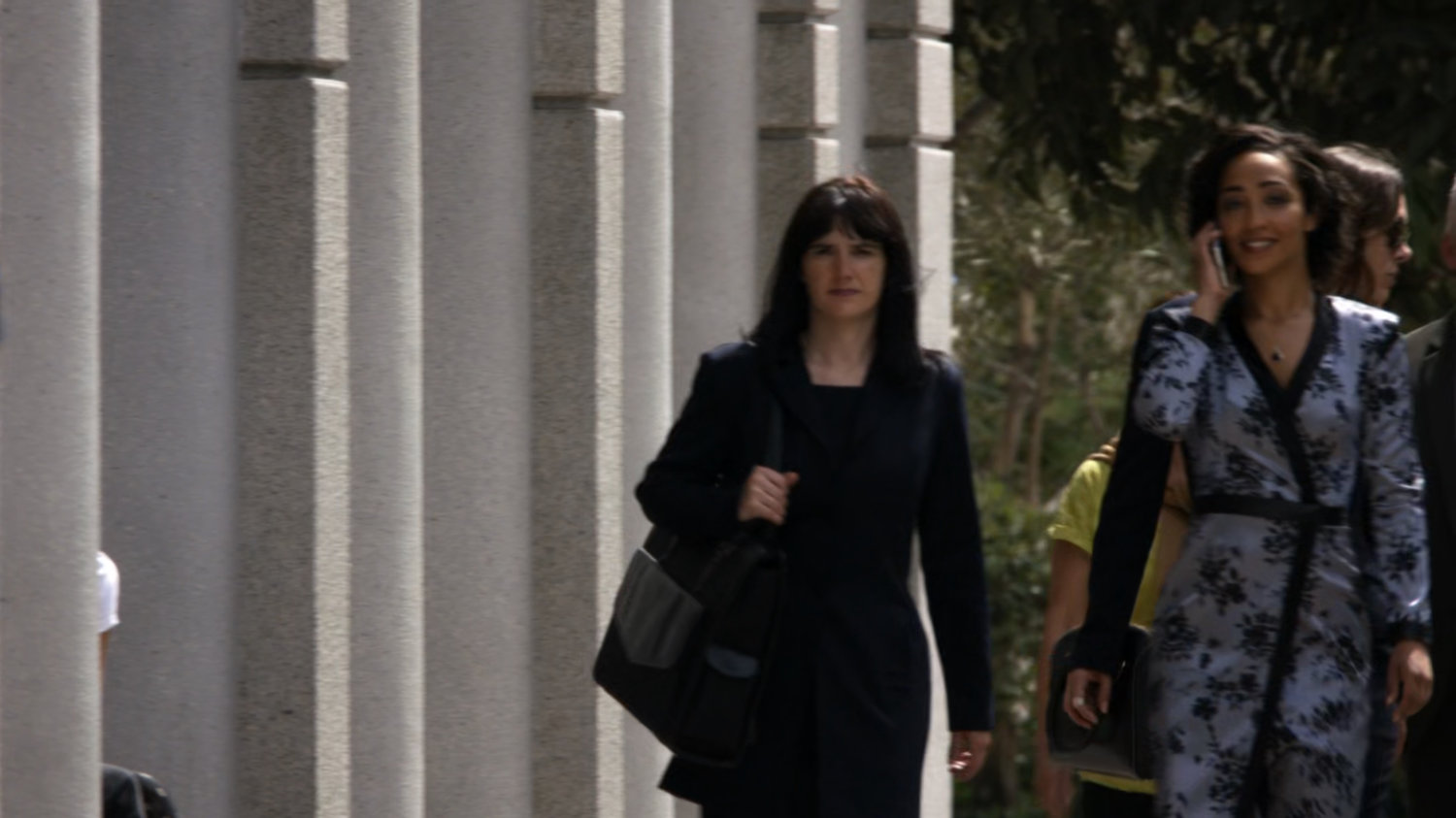 Raina walking down a sidewalk.