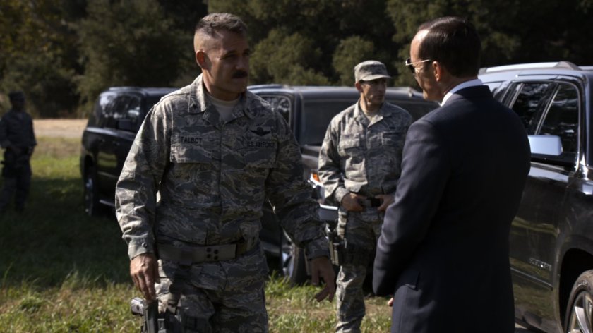 Coulson talks with Talbot in field.