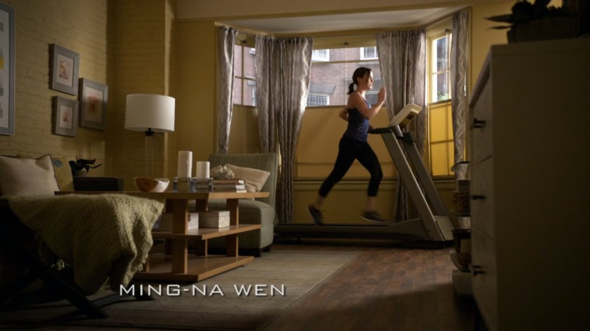 Jemma Simmons jogging on treadmill in her apartment.