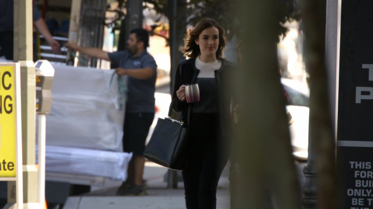 Jemma walks to work on a city street.