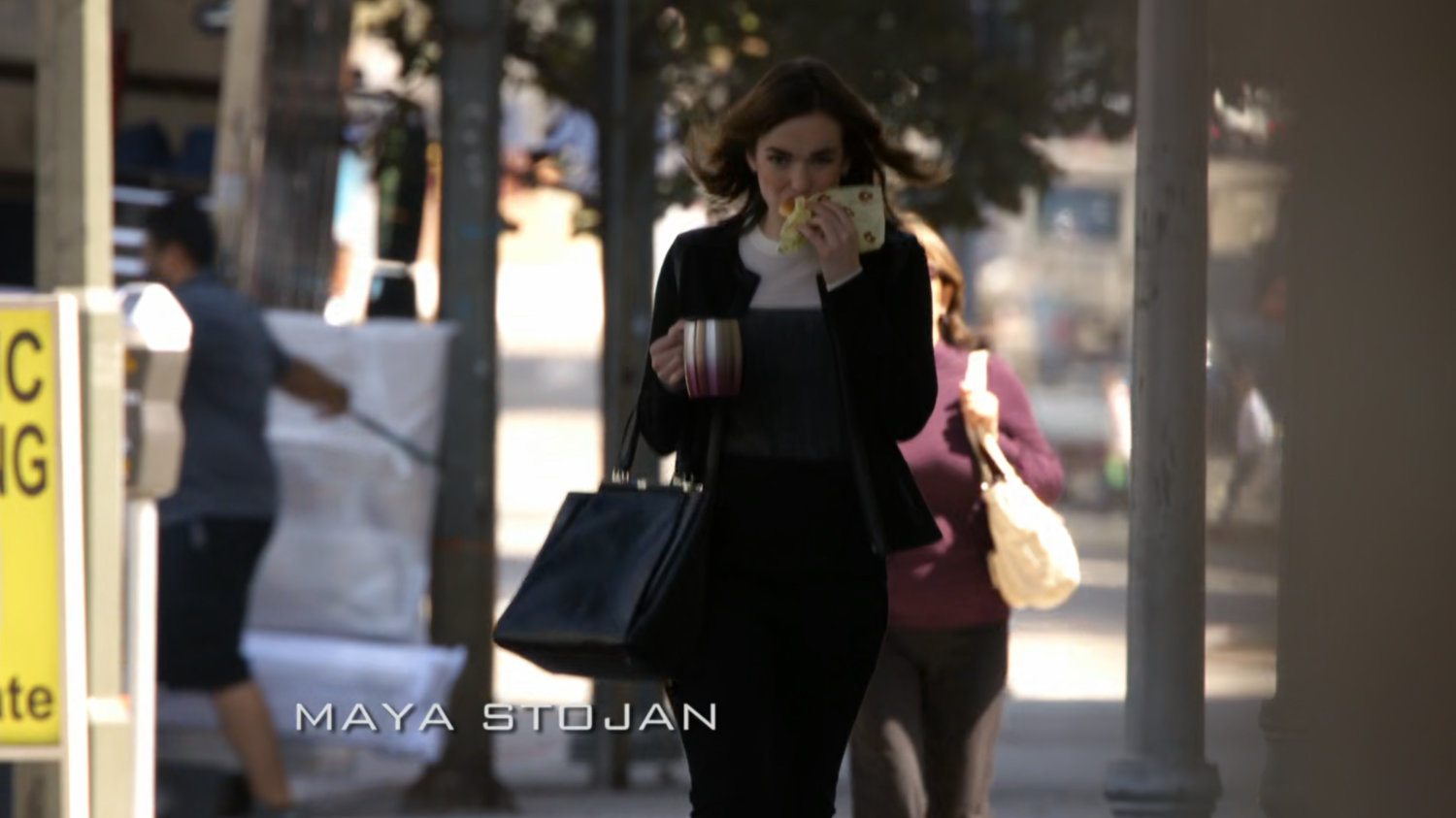 Jemma walks to work on a city street.