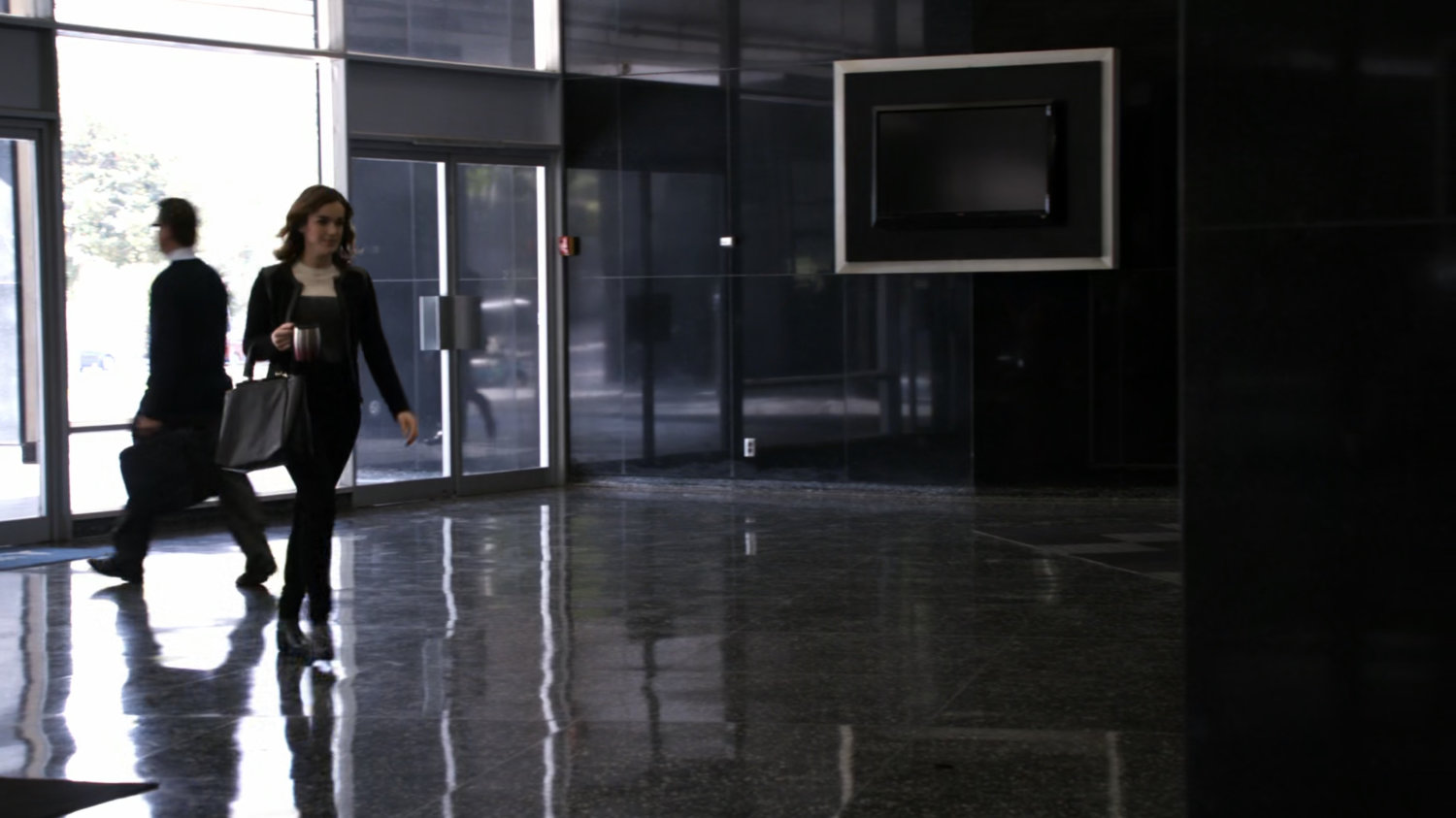 Jemma walks through the lobby of her office building.