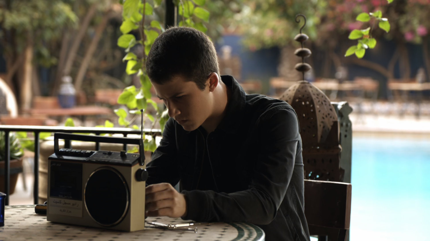 Donnie Gill working on radio at an outdoor table.