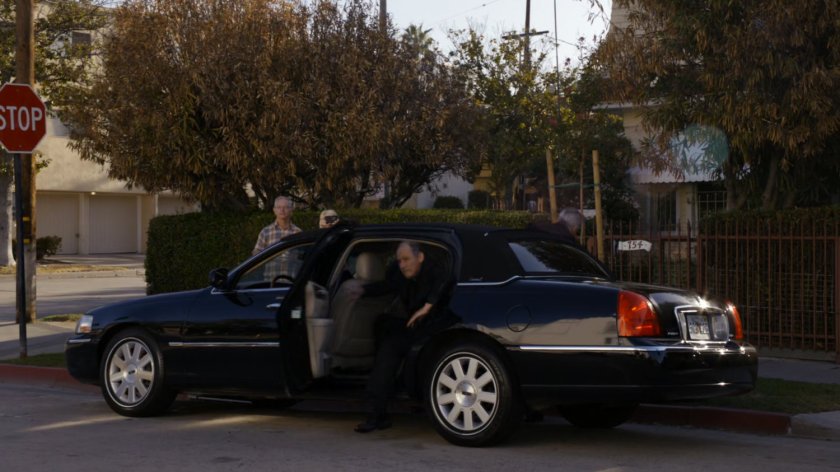 A priest gets out of a black sedan by Miami church.
