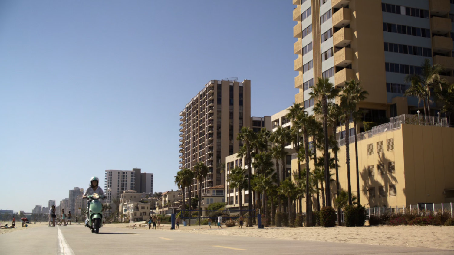 A scooter driving on Florida beach boardwalk.