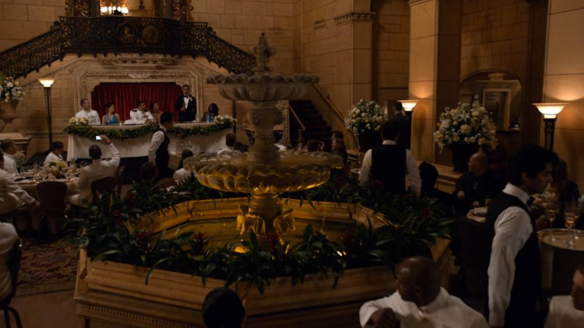 A wedding reception in a fancy hotel with a fountain.