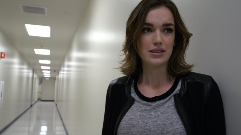 Simmons in stark white HYDRA labs hall.