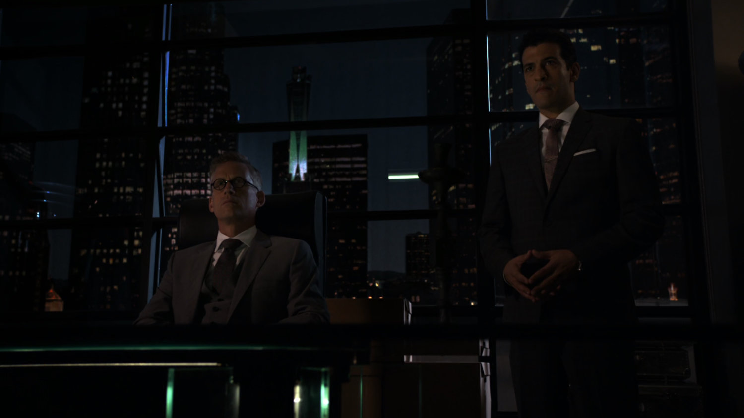 Daniel Whitehall and Bakshi in HYDRA office with skyline outside.