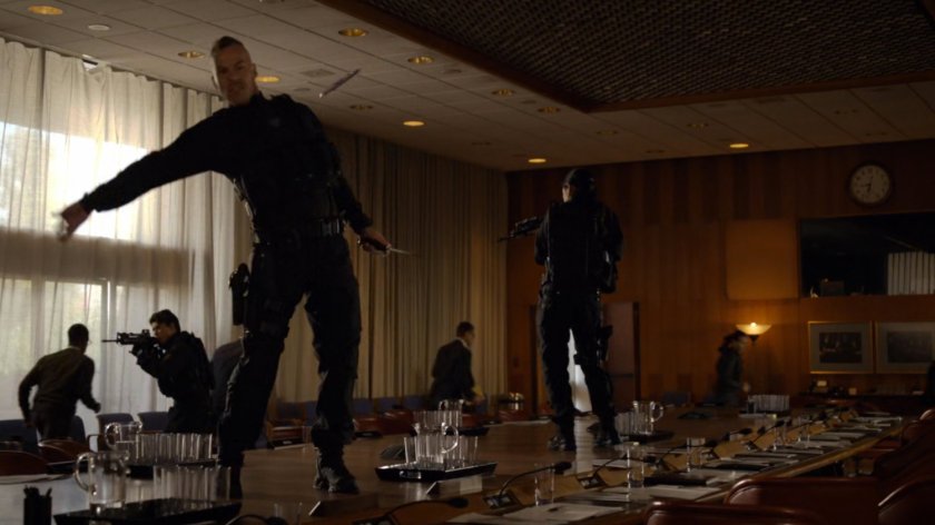 Terrorists on a table throwing weapons at members of the United Nations.