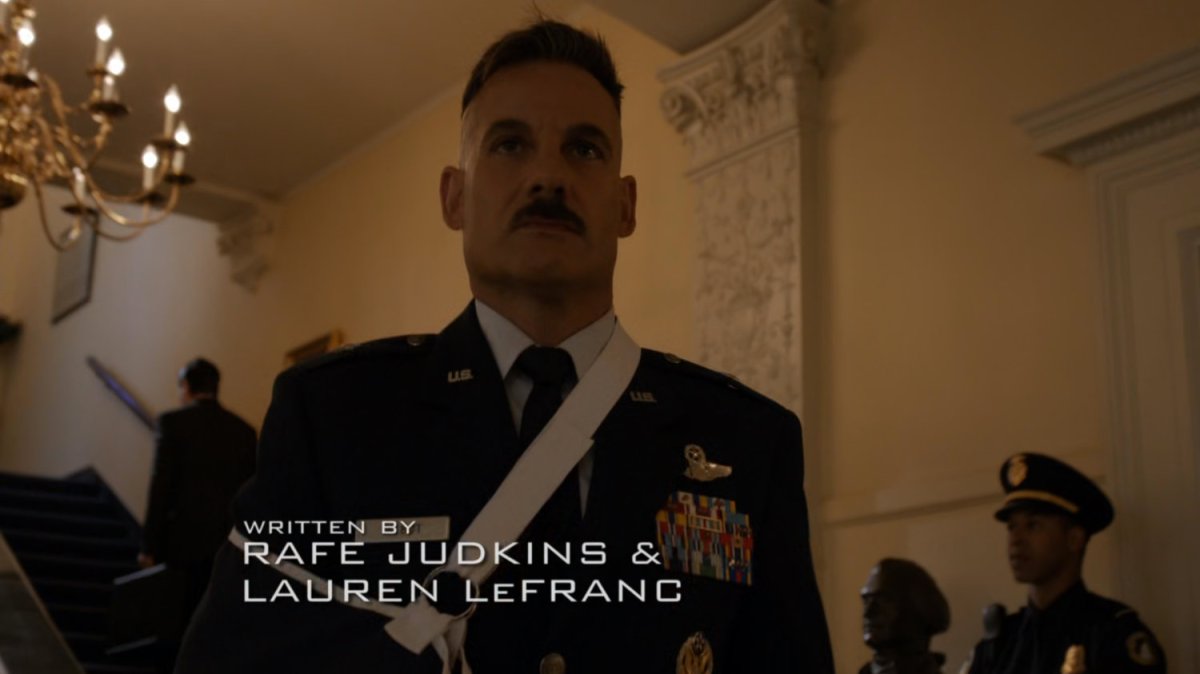 General Talbot descending stair wearing sling.