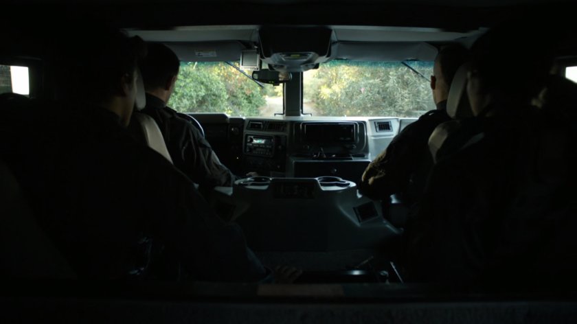 POV of humvee showing wooded forest.